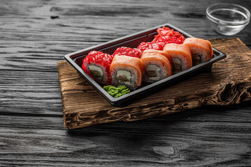 Sushi Rolls with Sauce on Dark Plate