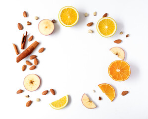 Creative layout made of orange, apple, cinnamon sticks and lemon on the white background. Flat lay. Food concept. Macro concept. 