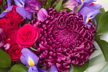 Close-up shot of a beautiful bouquet of irises, roses, chrysanthemums and alstroemerias