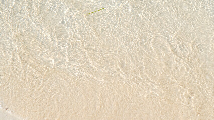 Smooth beach sand background with fine grains, natural texture, warm golden tones