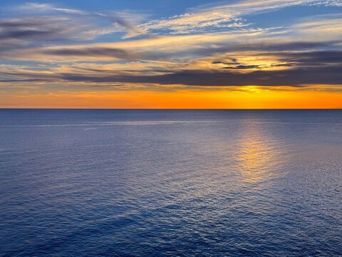 Dusk sky clouds over calm ocean