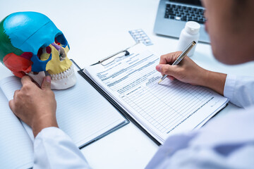 Doctor is dispensing medicine about brain tumor, neurology trauma or stroke. Professional senior...