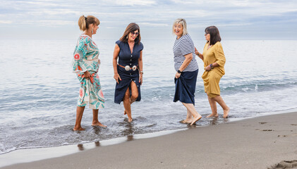 Group of mature women enjoying time together at the beach