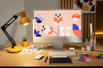 Designer working on a graphic tablet at a desk. Creative creation of graphic design, artist