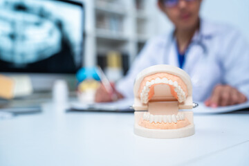 Dentist explaining tooth X-Rays to patient or consultation and recommend guidelines for...