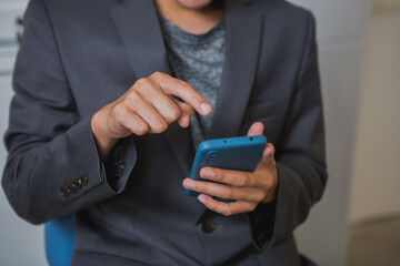 An Asian man works late at his desk papers, determined to meet his deadlines.