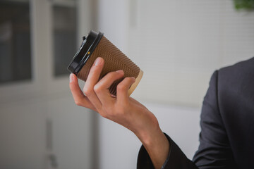 An Asian man works late at his desk papers, determined to meet his deadlines.