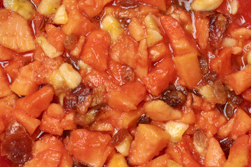 mixed fruit salads made from mixing chopped papaya, banana, plums and dates, delicious nutrient rich dessert in close-up full frame view, food background