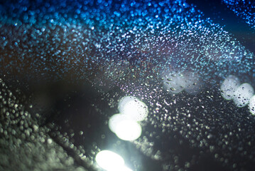 Blurred background with raindrops and lights.
