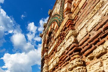 Remains of the Church of the Holy Archangels Michael and Gabriel in Old Town Nesebar, Burgas Province, Bulgarian Black Sea coast, partial close view against the sunny sky with clouds