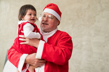 Santa Claus carrying baby girl