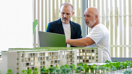 A real estate agent advises a client on the purchase of an apartment in a modern office modeled...