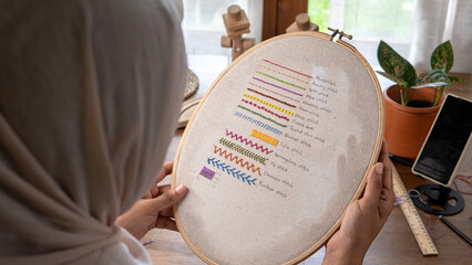 Muslim Woman's Handcraft: Head-Covered Artisan Holding Hoop with Basic Embroidery Stitches