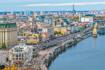 Aerial view of the bustling cityscape of Kyiv, Ukraine, featuring diverse architecture along the Dnipro River. The scene captures the vibrant urban life and the mix of historic and modern buildings