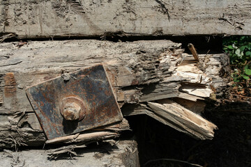 Splintering wood found in an abandoned area near a Ghost Town in Washington State. Has a large metal plate on the front, with a splintering break on the end.