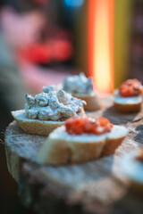 Assorted bruschetta with fresh toppings on a rustic wooden board. Great for food blogs, Italian-themed events, and appetizers menu, showcasing fresh ingredients.