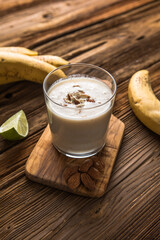 Healthy breakfast. Banana almond smoothie with cinnamon and oat flakes and coconut milk in glass jars