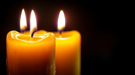 A soft, glowing candles in the dark background with a clear