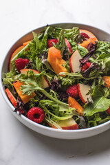 Tasty salad with apple, papaya, lettuce, top view.  Vegetable salad.
