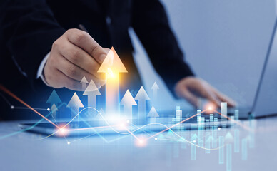 Business growth graph chart. Businessman using tablet analyzing sales data and financial...