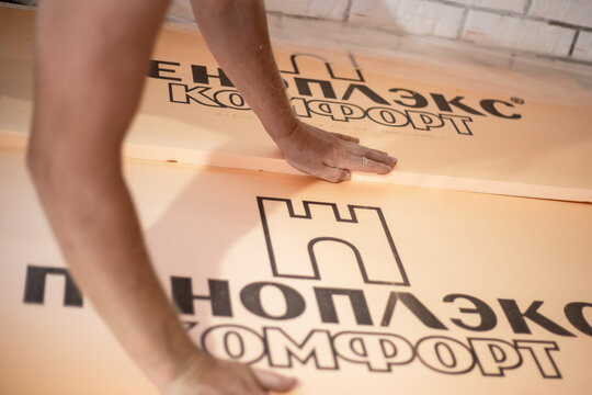Laying polystyrene foam Penoplex on the floor. Insulation of the floor surface in the house with environmentally friendly safe boards. Anapa, Russia