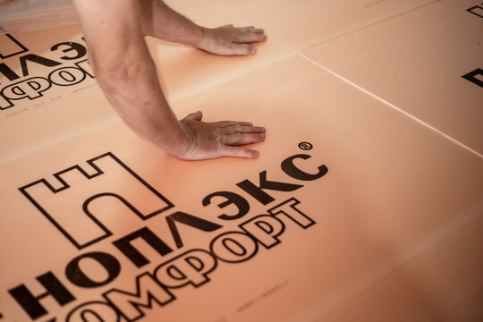 Laying polystyrene foam Penoplex on the floor. Insulation of the floor surface in the house with environmentally friendly safe boards. Anapa, Russia