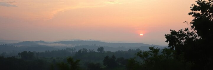 Obraz premium A tranquil sunrise over a vast expanse of rolling hills, misty valleys, and distant mountains, nature, serene