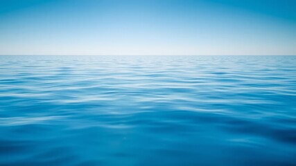 Obraz premium A tranquil ocean background with gentle ripples and a clear blue sky reflecting on the water surface, nature, scenic
