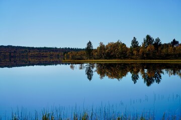 Norwegian mountain lake under a bright blue sky, north of the mining town of Roeros, Norway