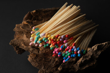 large wooden matches with vibrant sulfur heads resting on aged timber, symbolizing warmth and nostalgia, evoking memories of cozy gatherings and rustic charm