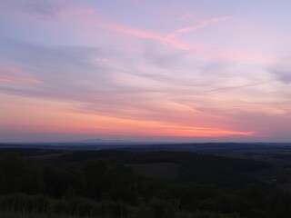 Fototapeta premium A serene landscape at dusk with a sun setting behind the horizon, casting a warm glow over the peaceful scene, serene, twilight