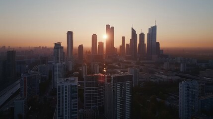 Skyscrapers silhouetted against the setting sun create a dramatic cityscape, exuding warmth and vibrancy.