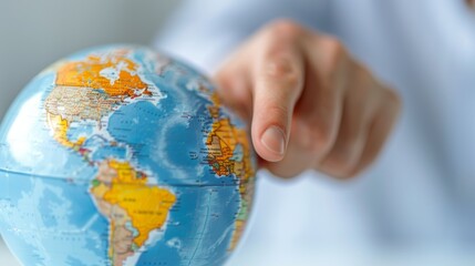 Spinning Globe and Hand Pointing to Global Travel Destinations on Map