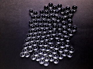 Small glass balls on black background