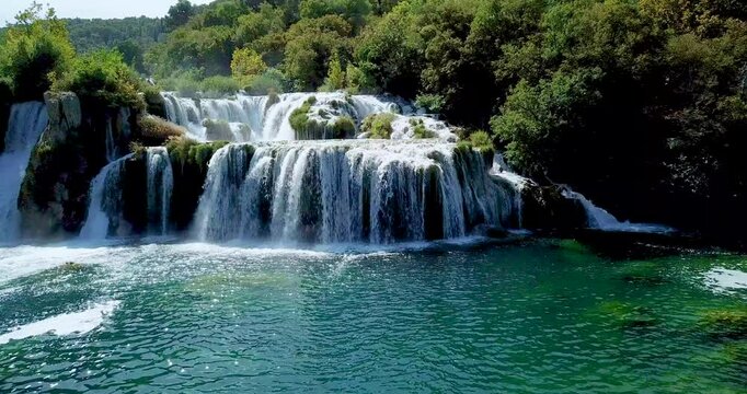 Stunning aerial drone footage of Krka National Park waterfalls in Croatia, captured by a Mavic Pro. This natural paradise showcases cascading waterfalls surrounded by lush green forests, ideal for tra