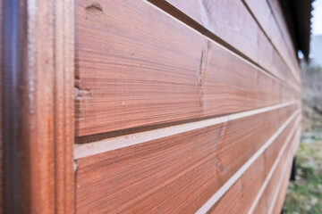 Side view of a wooden house wall with slats