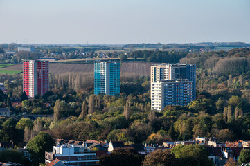 High angle panorama over the Brussels skyline and green suburbs with colorful apartment blocks in...