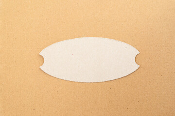 Cardboard label cutout on a cardboard background