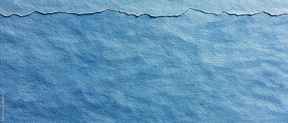 Poster a textured blue paper background with a distinct wavy edge, ideal for creative designs and artistic 