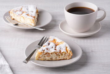 Two delicious pieces of cottage cheese casserole on a light wooden table.