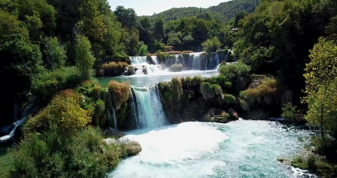 Stunning aerial drone footage of Krka National Park waterfalls in Croatia, captured by a Mavic Pro. This natural paradise showcases cascading waterfalls surrounded by lush green forests, ideal for tra