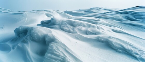 A vast expanse of snow dunes undulates across the frosty landscape, creating a surreal and tranquil atmosphere in the cold wilderness.