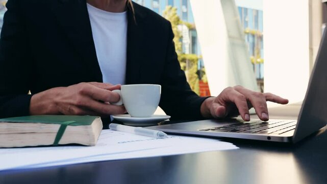 Businessman Uses Laptop, Waiting for a Flight in Airport Terminal or train station, Traveling Entrepreneur Working Online On Computer Sitting in a Boarding Lounge of Airline Hub with Airplanes