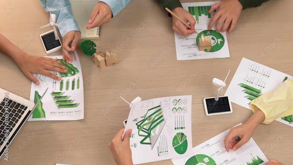 Poster excellent business team discussing on eco house project at meeting table with windmill design model 