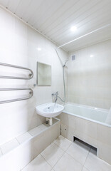 Bright Elegant Home Bathroom Interior Design With White Sink. Mirror and Faucet. LED Lights. Shower Area, Tiled Floor and Walls. Heater