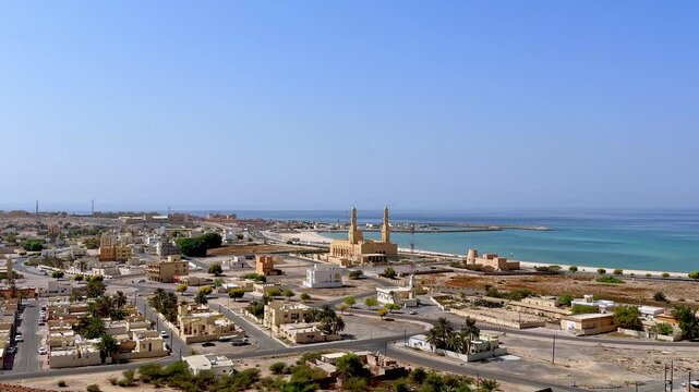 coastal view of Bukha city with traditional architecture and a mosque, Musandam, Oman