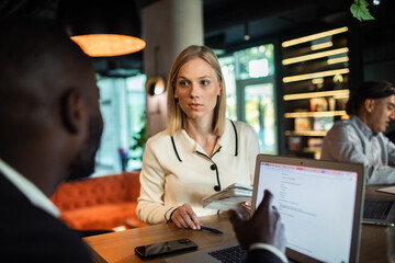 Business team collaborating on project in modern office environment