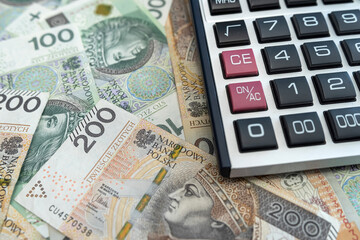 polish zloty money banknotes with calculator. 200 100 pln bills business concept