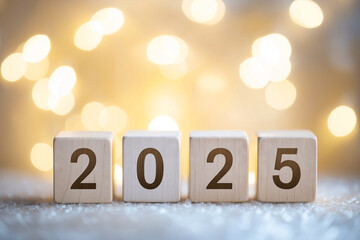 Wooden Blocks Displaying 2025 with Festive Lights Background