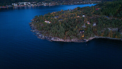 Naklejka premium Aerial View of Forested Peninsula in Calm fjord